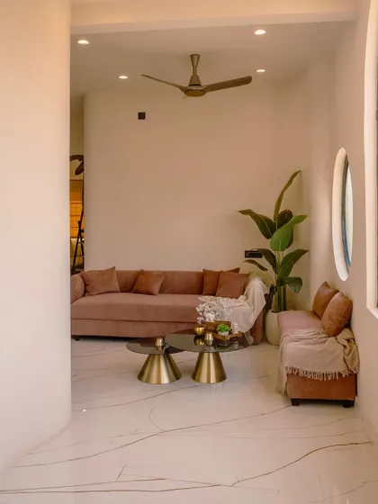 An angled view of the family lounge, showing how the space is defined by curved walls and minimalist furniture.