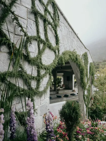 Another angle of the custom greenery installation. Every curve and line was intentionally placed by our team to create a sense of movement and natural elegance on the building's facade.