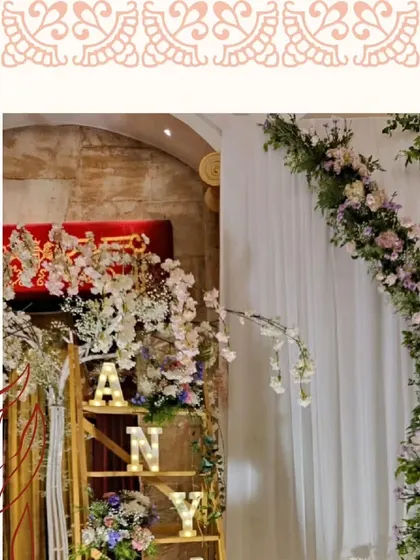 A close-up of the floral arch and the personalized ladder shelf.