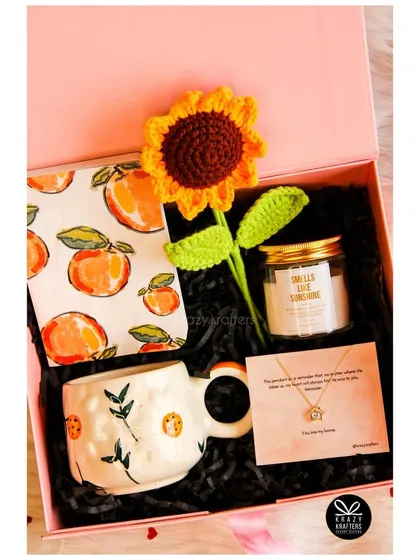 Our 'Sunshine' hamper, featuring a personalized necklace, a crochet sunflower, and a 'smells like sunshine' candle, is a perfect example of thoughtful curation.