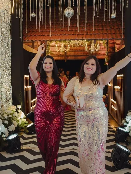 Guests make a grand entrance through the shimmering sangeet walkway, ready for a night of celebration.