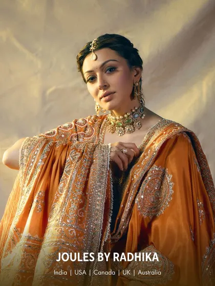 A full look of Hansika Motwani in a heavily embroidered orange outfit, her elegance amplified by my bespoke jewelry.