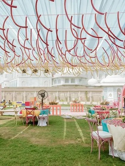 The ceiling decor for the carnival Mehendi, featuring hanging colorful pool noodles to create a playful and unexpected textural element.