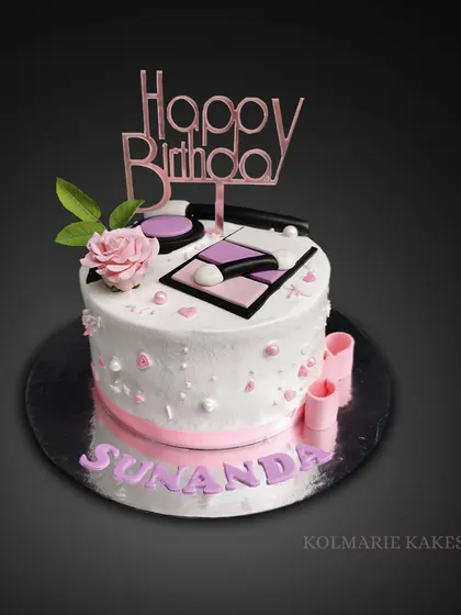 A simple yet elegant take on the makeup theme. This cake is topped with a "Happy Birthday" topper and a few essential edible makeup items and a delicate pink sugar rose.