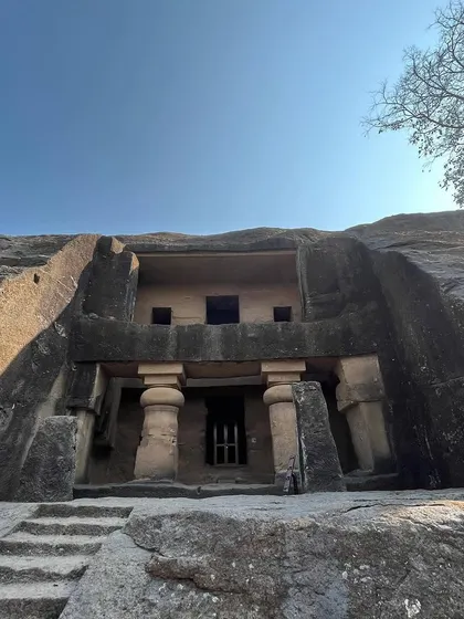 The entrance to one of the rock-cut caves, showing the simple yet imposing facade carved directly from the mountain.