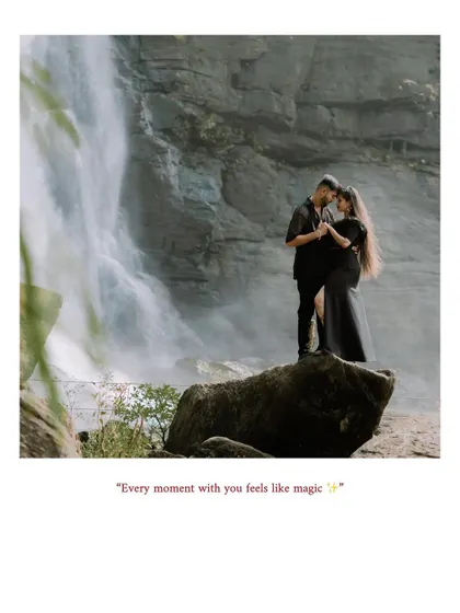 A wide shot of a couple standing on a rock in front of a waterfall, capturing a magical moment.