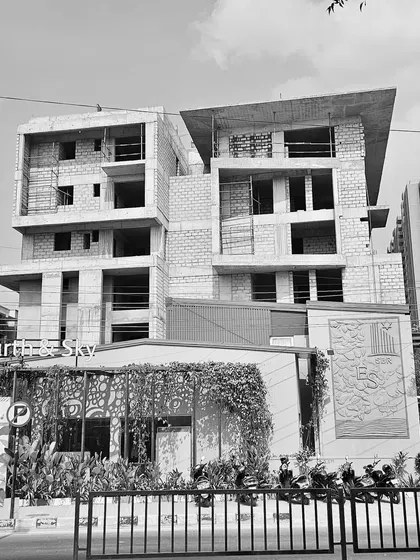 Black and white site photos documenting the construction of the SBR Earth & Sky project in Bangalore, capturing the raw concrete structure and powerful forms.