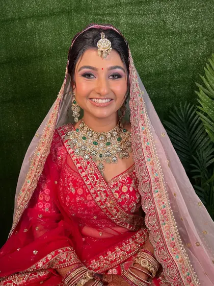 A bright, happy smile from the bride. The makeup is fresh and luminous, perfect for a day wedding.