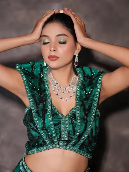 A close-up of the glam look, showing the green shimmer eyeshadow and bold lip.