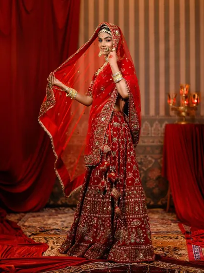 The full grandeur of our 'Padmavat' recreation. This side profile highlights the volume of the lehenga and the delicate tassels, perfect for a royal bridal entry.