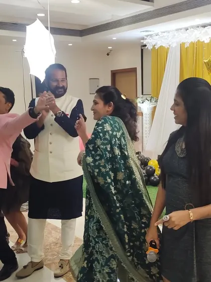 Interacting with the birthday boy and his wife during the celebration. These personal touches help make the event feel intimate and special.