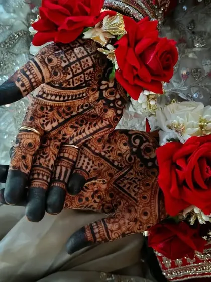 The deep henna stain looks stunning when paired with traditional floral jewelry and a bridal outfit. This is the kind of picture-perfect result I aim for with every bride.