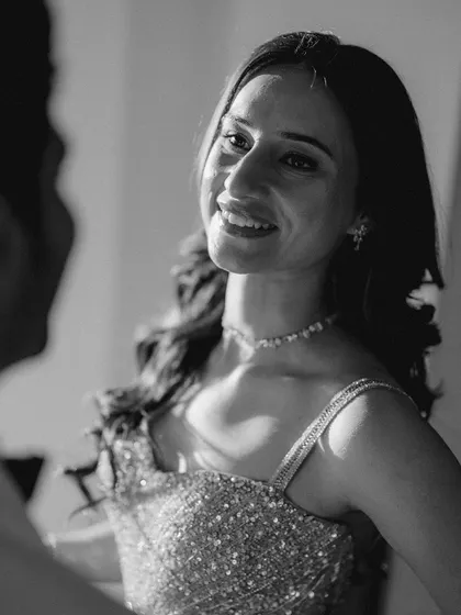 A beautiful, soft-focus portrait of the bride-to-be, capturing her radiant smile as she looks at her partner.