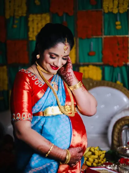 A glowing look for a beautiful mom-to-be at her baby shower. The makeup is bright and joyful, with a classic red lip and shimmery eyes.