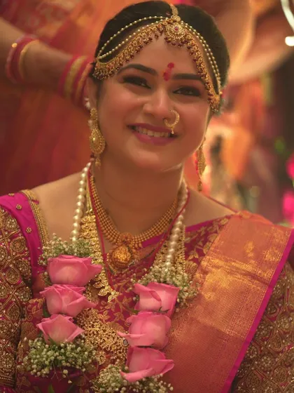 A happy close-up of my bride Sanjana during her muhurat, her smile lighting up the frame.