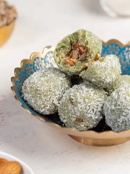 Paan Laddoos, a unique and flavorful festive treat. The vibrant green color and coconut coating make for a beautiful and unusual food photograph.