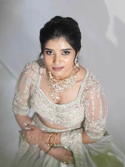 A close-up of the client's beautiful smile and her stunning ensemble. The intricate details of her corset blouse are simply breathtaking.