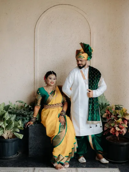 A lovely portrait of the couple, with the bride seated, creating a different dynamic and showcasing her full attire.