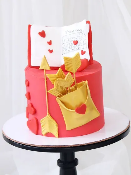 Another look at my Valentine's Day special. The vibrant red fondant and golden cupid's arrows make this two-tiered cake a bold and romantic statement.