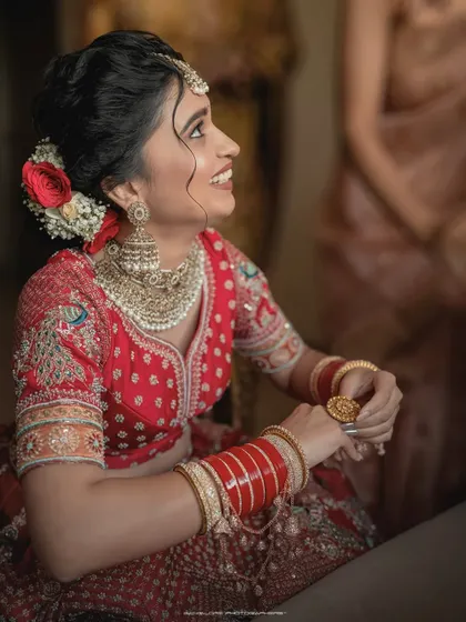 A moment of laughter and joy. This candid shot captures the bride's happiness as she prepares for her ceremony, her smile lighting up the frame.