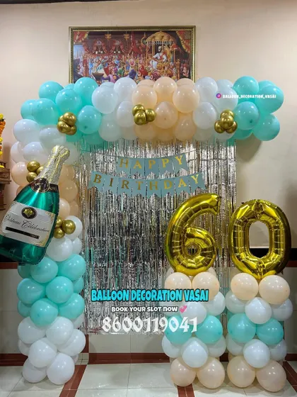 A 60th birthday celebration with a simple balloon arch. The teal, peach, and white colors create a fresh and happy vibe.
