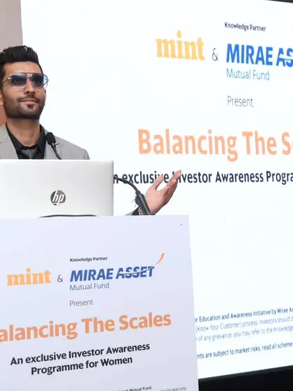 Using expressive gestures to emphasize a point during the financial awareness program. My dynamic presentation style helps keep the audience captivated throughout the event.