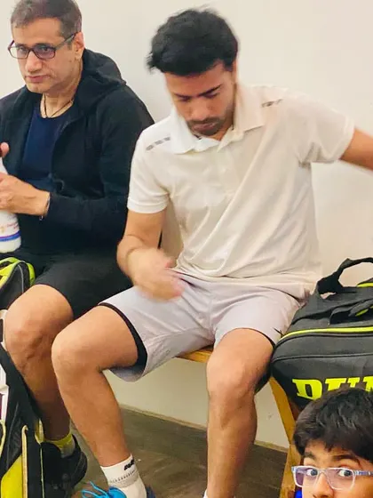 A candid moment on the bench, preparing for my next match. The grind never stops, even for the coach.