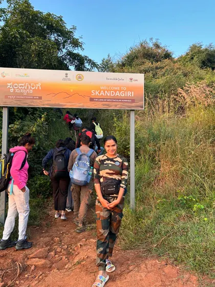 A trekker at the entrance of the Skandagiri trail, ready to begin the climb.