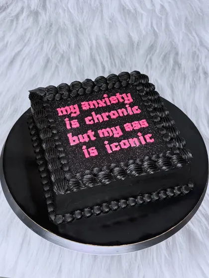 This is for everyone who knows their worth. A black buttercream cake with glittery pink text that says it all: "my anxiety is chronic but my ass is iconic". Let's celebrate you, your confidence, and your iconic self with a cake that's just as bold.