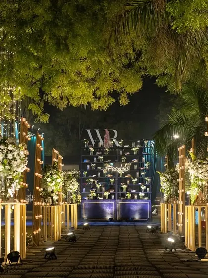 The candle-lit aisle leading to the main event space. I used gold pillars of varying heights to create a modern and sculptural pathway of light.