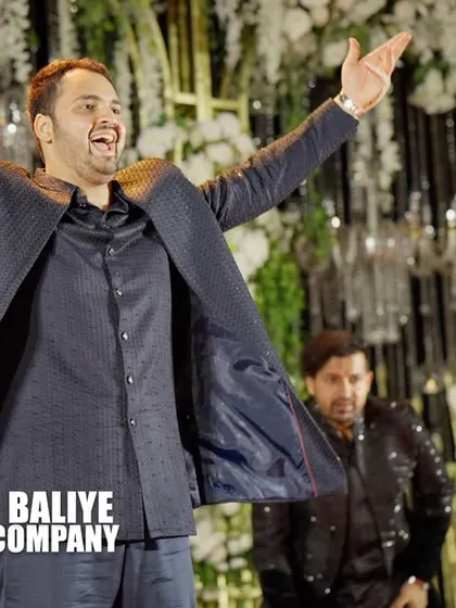 The joy and confidence of a well-rehearsed performance. This groomsman is all smiles as he nails his part in the group dance.