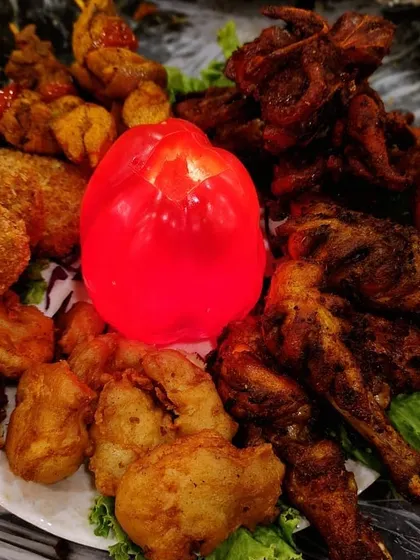 This platter is all about abundance. It’s loaded with a variety of our best fried chicken, fish, and kebab starters, with a lit bell pepper in the center for a dramatic touch.