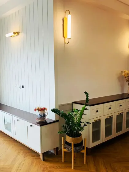 "Good houses take work." A memory of making a beautiful home, this shot shows the living and dining areas with custom consoles and beautiful lighting.