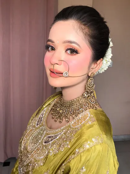 A smiling portrait that captures the freshness and beauty of the Pahadi-inspired makeup.