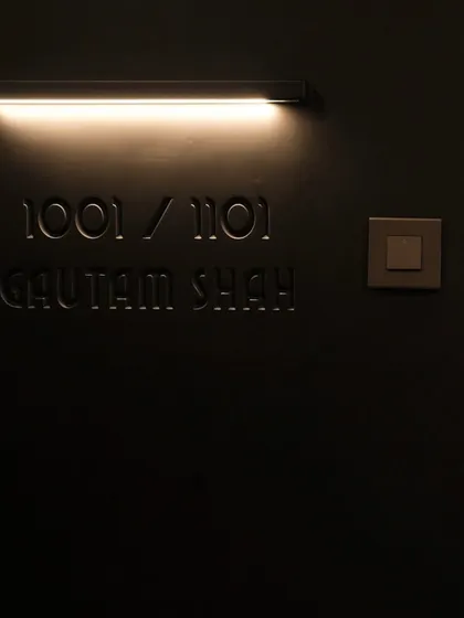 The engraved names and flushed wall light on the main door are subtle details that add a layer of personalization and sophistication. It’s these small touches that make a design feel truly bespoke.