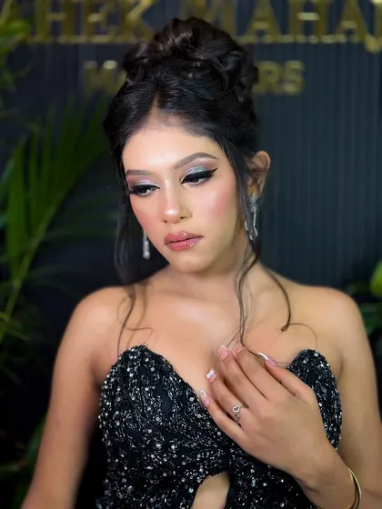 Another beautiful shot of the model in the black sequined dress, showcasing her elegant updo and stunning makeup.