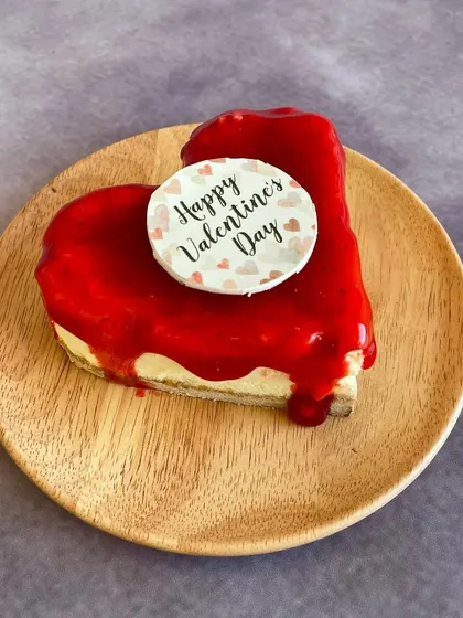 Our heart-shaped Strawberry Baked Cheesecake, specially made for Valentine's Day. A romantic and delicious way to celebrate love, with a bright strawberry glaze over our classic cheesecake.