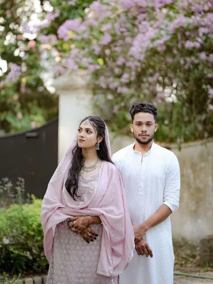 A portrait of a couple in coordinated pastel outfits, showcasing a modern and elegant style for a pre-wedding event.