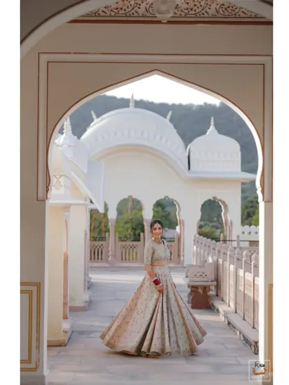A beautiful bridal portrait at The Jaibagh Palace, with the architecture framing the bride perfectly.