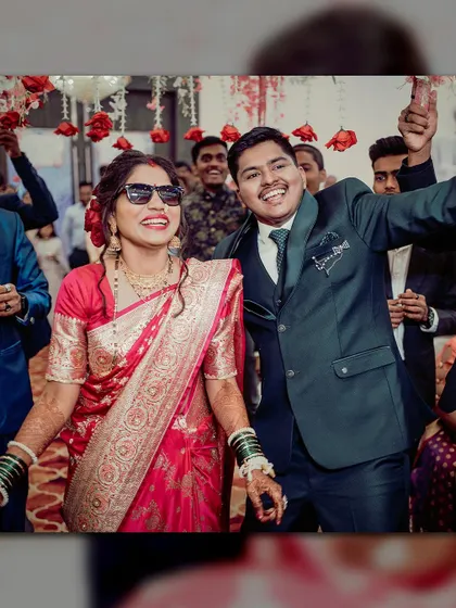 The bride and groom enjoying their reception party. Their big smiles and cool sunglasses show they are having the time of their lives.