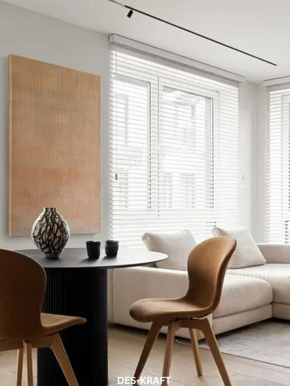 An overview of the open-plan space, showing how the living and dining areas are defined yet connected, unified by a consistent color palette and abundant natural light.