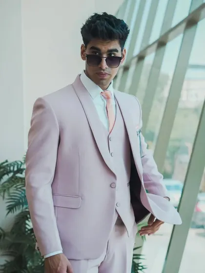A different angle of the pastel pink suit, showing its clean lines and modern appeal.