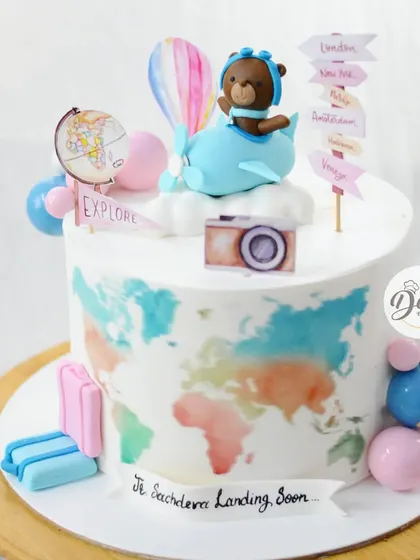 Another look at the "Baby Landing Soon" cake, showing the cute luggage and hot air balloon details.