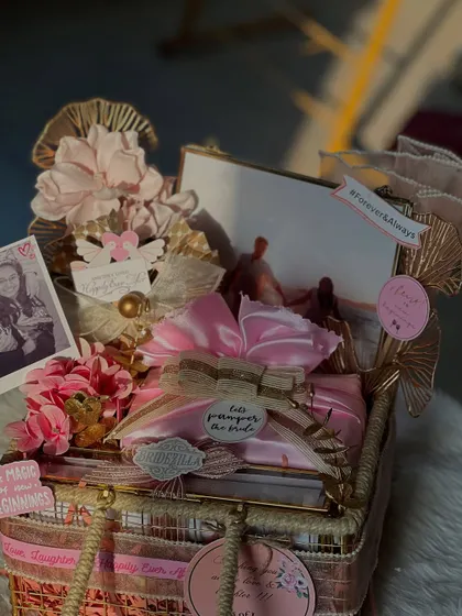 A stunning hamper from "The Bride Edit" collection. This one is all about pampering, with a beautiful mix of personalized items and keepsakes wrapped in soft pink and gold tones.