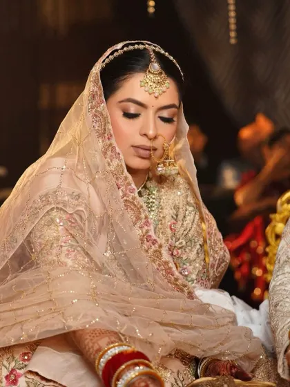 Muskan looks serene and beautiful during her ceremony. Her soft, subtle makeup perfectly complements her pastel outfit, creating a look of understated elegance.