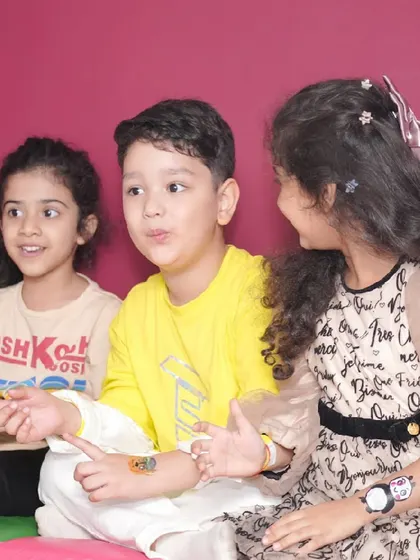 A young boy proudly shows off his new temporary tattoo, one of the fun activities we offer.