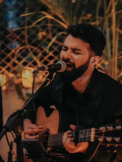 Our singer leans into the melody with an acoustic guitar during the October Diwali celebration.