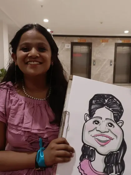 A student in a lovely party dress with her portrait.