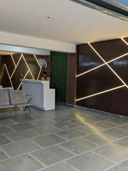 The completed reception area, showcasing the dramatic effect of the custom LED light pattern on the wall. This feature adds a dynamic and modern touch to the space, making it memorable for visitors.