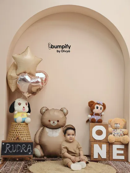 A quiet moment during his first birthday shoot. Seated amongst his teddy bear friends, this little boy looks so sweet and thoughtful.